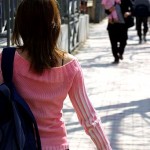 Student walking along pavement