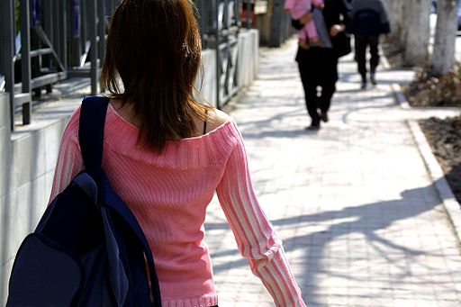 Student walking along pavement