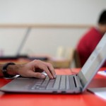 A distance learning student studying with a laptop