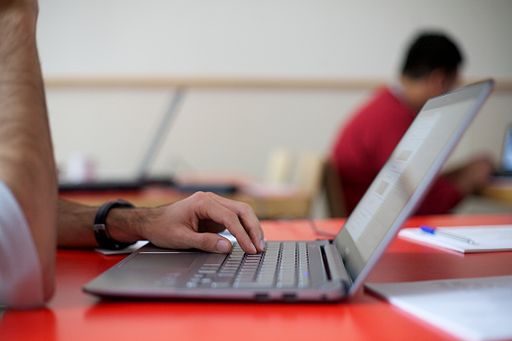 A distance learning student studying with a laptop