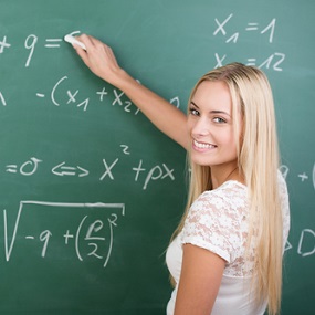 Higher Level GCSE Maths Student writing on a blackboard