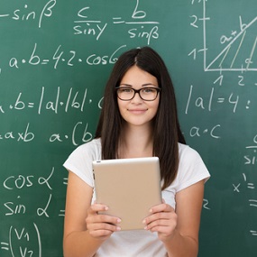 Maths Student in front of board covered in equations