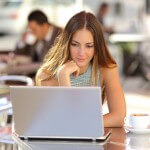 A female distance learning student studying from a laptop