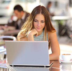 A female distance learning student studying from a laptop